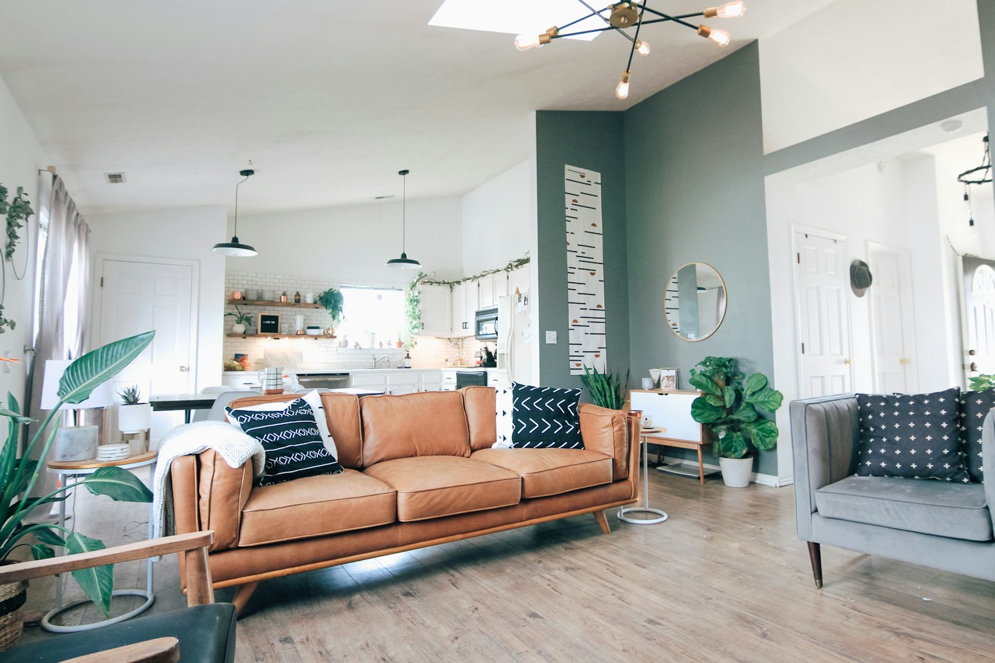 A bright living room with a sofa and house plants